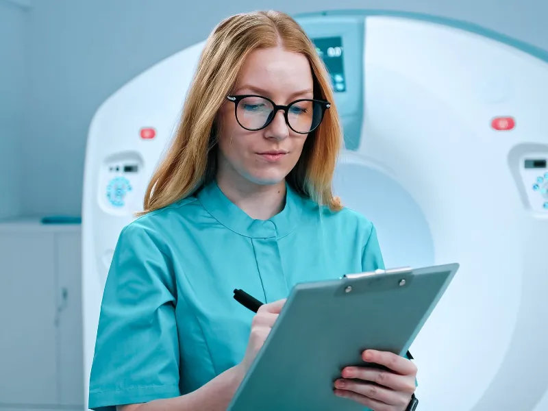 Neurologist woman doctor in glasses, oncology in magnetic resonance imaging